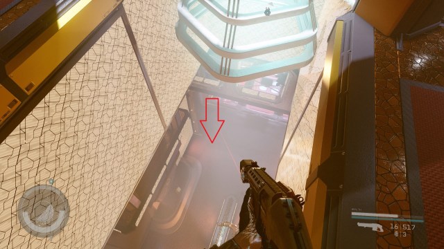 Screenshot of player holding gun in Starfield. There is an arrow pointing towards a corridor.