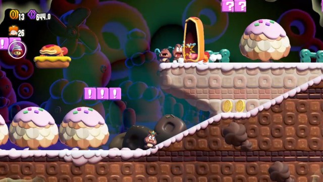 A Super Mario Bros. Wonder screenshot of Daisy as a Goomba, while a Maw-Maw eats a sleeping Goomba on a higher platform.