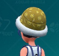 Pokemon Scarlet and Violet screenshot of a yellow patterned fur bucket hat.