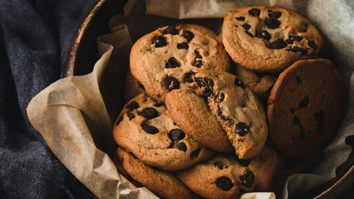 A photograph of a basket of chocolate chip cookies.